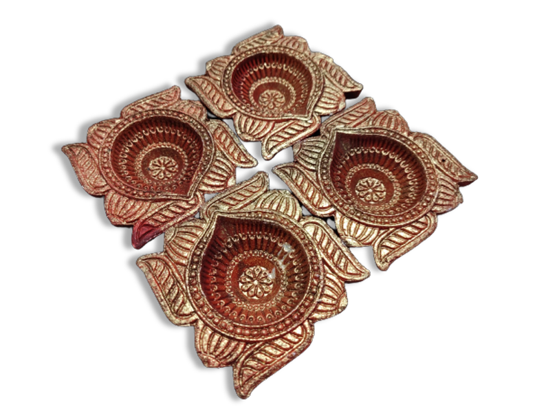 Set of four terracotta oil lamps with floral patterns.