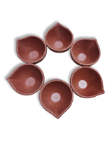 A set of six red clay Diya (oil lamp) holders arranged in a circle.