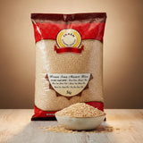 Bag of Annam Brown Sona Masoori Rice with a bowl of rice on a wooden surface.