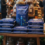 Daawat Basmati Rice packages on a wooden shelf with jars in the background