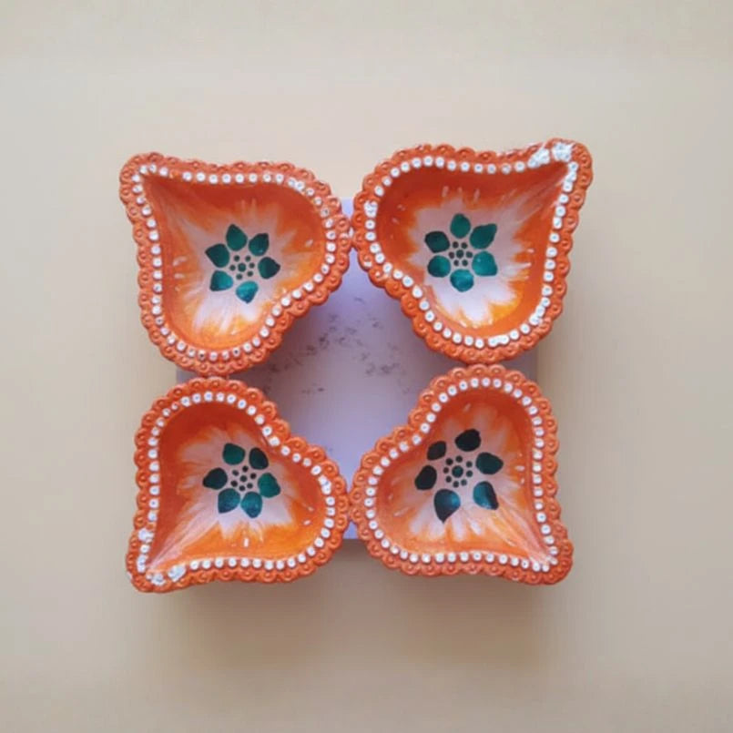 Decorative ceramic dish with orange border and floral design on a beige background