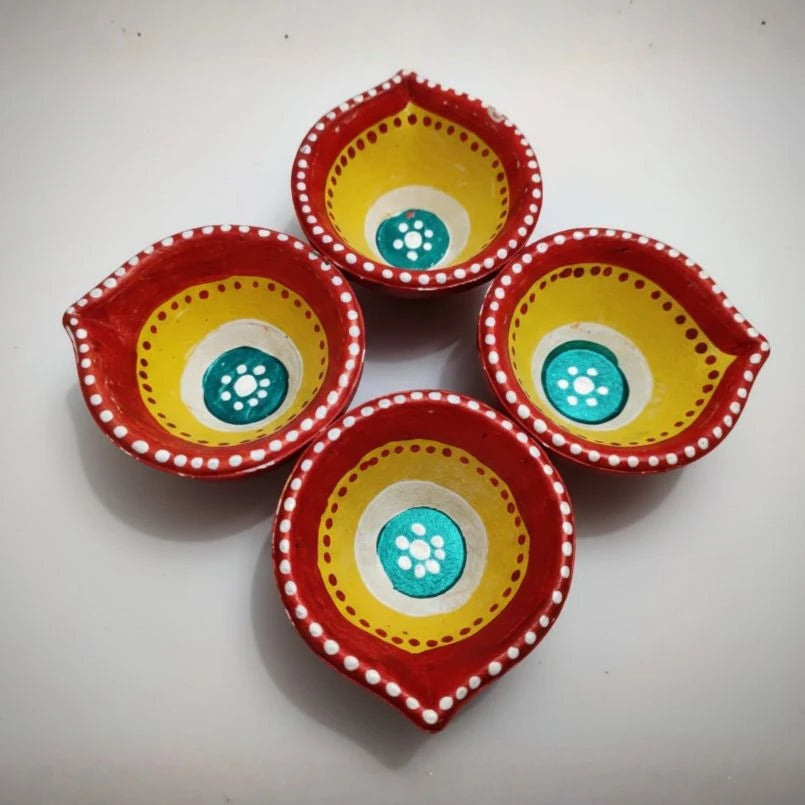 Four colorful ceramic bowls with red, yellow, and turquoise patterns on a white background