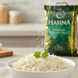 Steaming bowl of rice with a green 'HASINA' rice bag in the background