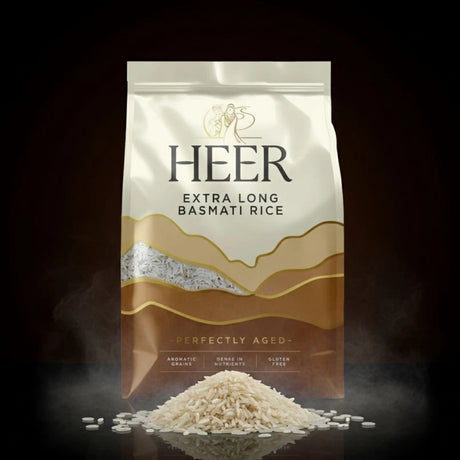 HEER Extra Long Basmati Rice packaging with rice spilling out on a dark background